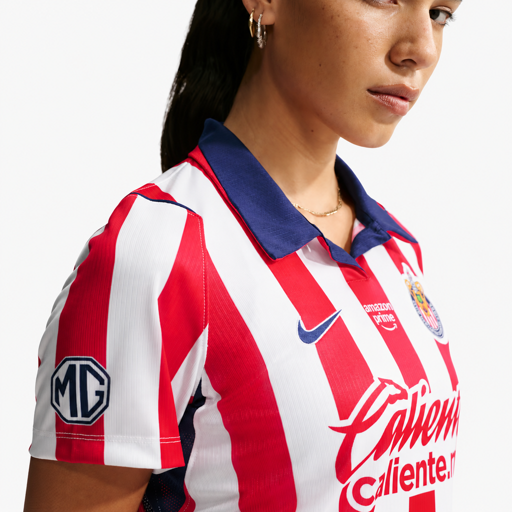 Chivas women's home jersey collar, crest and fabric detail — AI-assisted background cleanup
