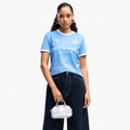 Manchester City 2026/27 home women's jersey — front on female model; AI-assisted background and framing edit