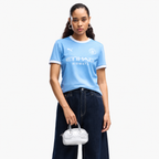 Manchester City 2026/27 home women's jersey — front on female model; AI-assisted background and framing edit