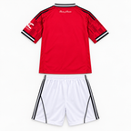 Manchester United 2025/26 Home Kids Kit - shirt and shorts back; AI-assisted studio visualization based on the supplier-verified kit