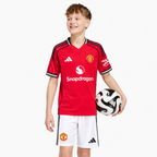 Manchester United 2025/26 Home Kids Kit - child model; AI-assisted studio visualization based on the supplier-verified kit