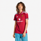 Manchester United 2026/27 Home Women's Jersey - woman wearing the shirt; AI-assisted studio background adaptation