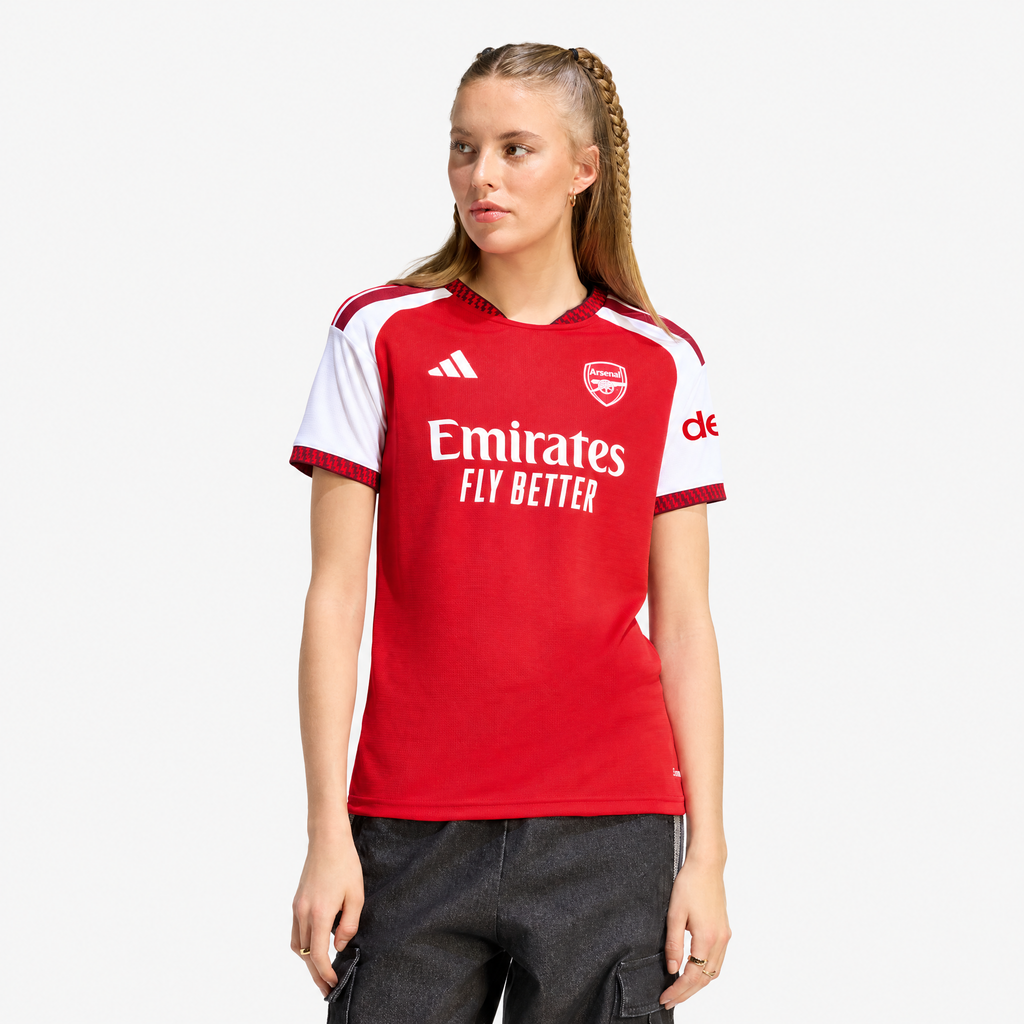 Arsenal 2026/27 Home Women's Jersey - woman wearing the shirt; AI-assisted studio background adaptation